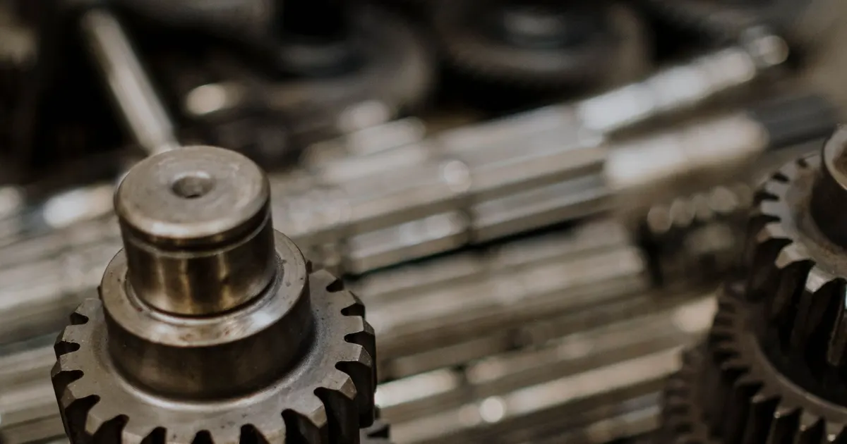 Steel gears and shafts on a workshop table, typical applications of 4140 steel machining