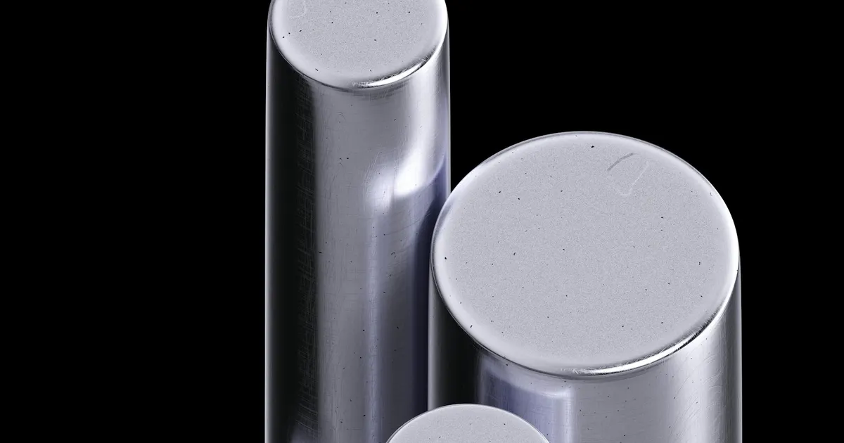 Polished round metal bars standing on end, a stock form used when comparing 6061 vs 7075 aluminium for machined parts