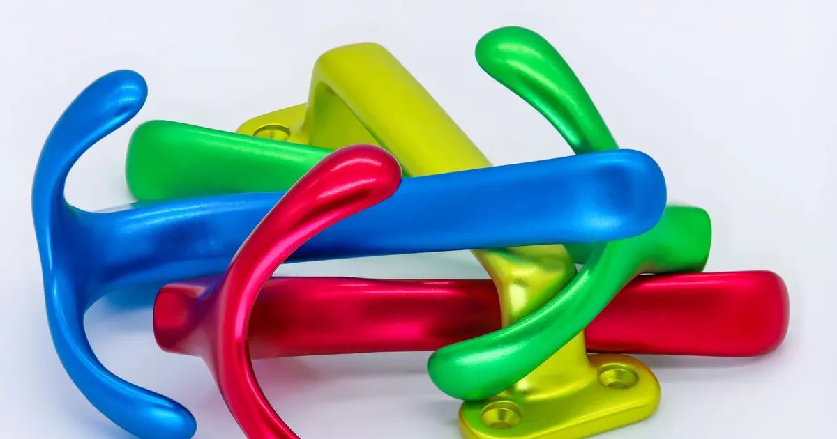 Brightly coloured glossy metal hooks showing the kind of coloured surface finish used for anodizing in Vietnam